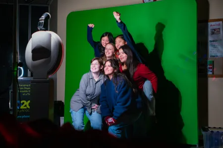 Students posing for a photobooth at a dining services event
