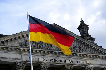 Flag of Germany in front Dem Deutschen Volke building