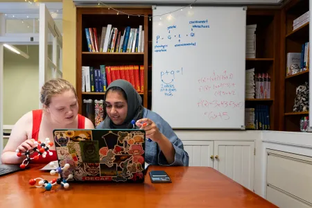 Two students at Quantitative Center table