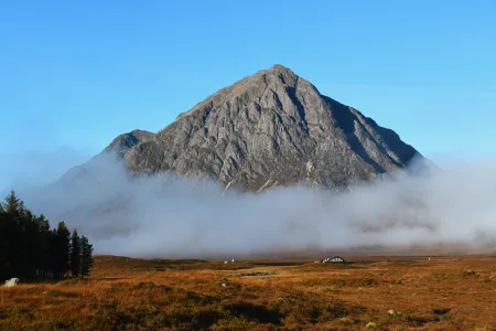 an image of a mountain in Scotland rising out of a cloud of mist