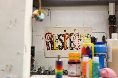 Art Club studio with a painted colorful RESPECT sign