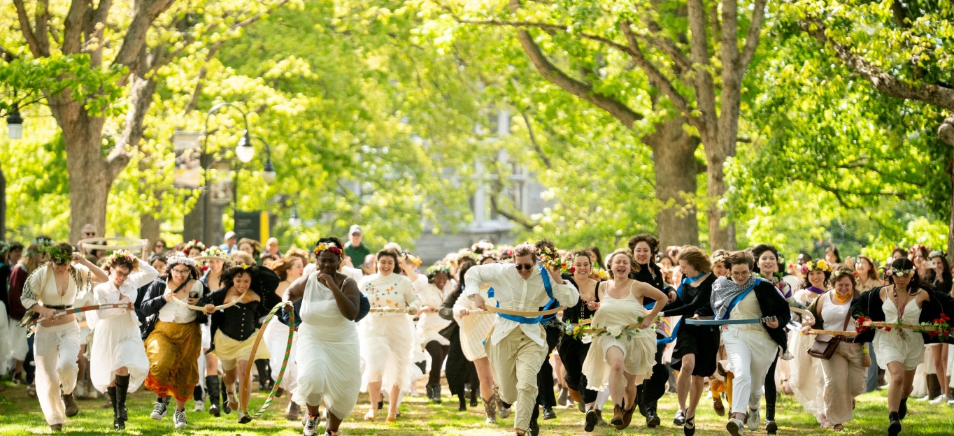 Students run down Senior Row during May Day