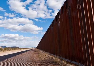 Fence at the border against a blue sky