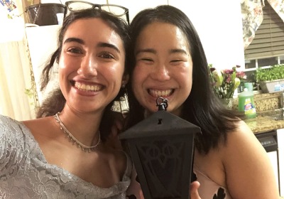 Dounya Ramadan and Lizzy Lee standing together, holding a lantern