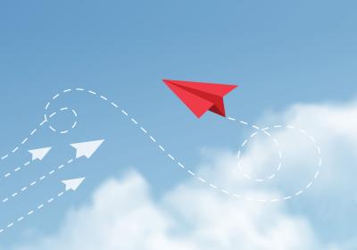 Illustration of paper airplanes, three going in one direction and a fourth going in a different one