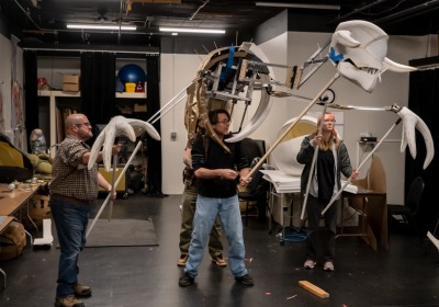 Jeremy Villines, Russ Vick, Jason Hines, and Cricket Bradford test an early iteration of the dragon puppet Fafner for the Atlanta Opera’s production of Siegfried.