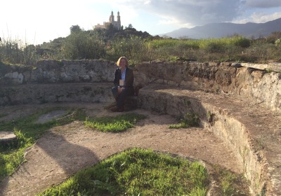 Catherine Conybeare sitting in the ruins of Augustine's Church