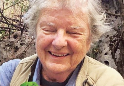 Kate Wallace holding a tody, a native Caribbean bird.