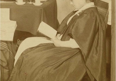 Umeko Tsuda (Class of 1890) studying in a dorm room.