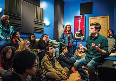 Because the field of audio production has been male-dominated for so long, Weidman wanted to demystify a space where women haven’t been at the controls by organizing a field trip to a local recording studio. Professor Teaching