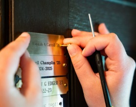 Hannah Carroll installs her brass nameplate