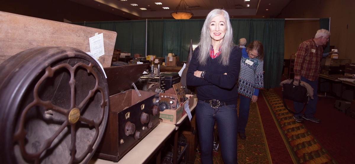 Barbara Kevles standing near vintage equipment