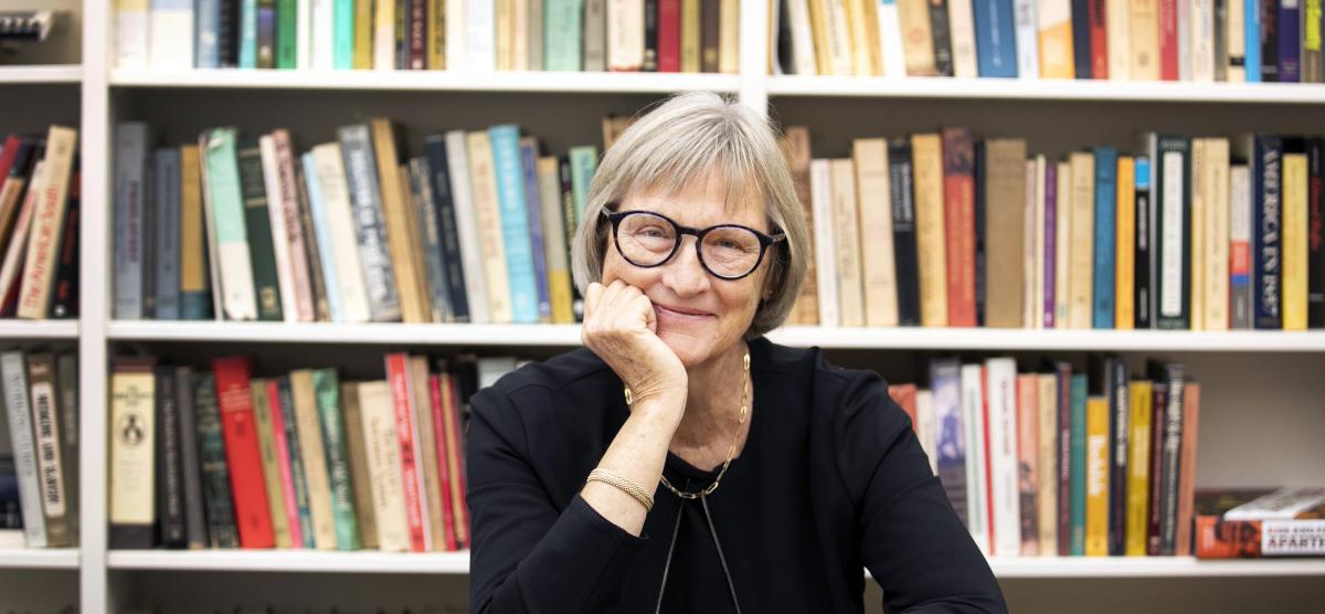 Drew Gilpin Faust with a bookshelf in the background
