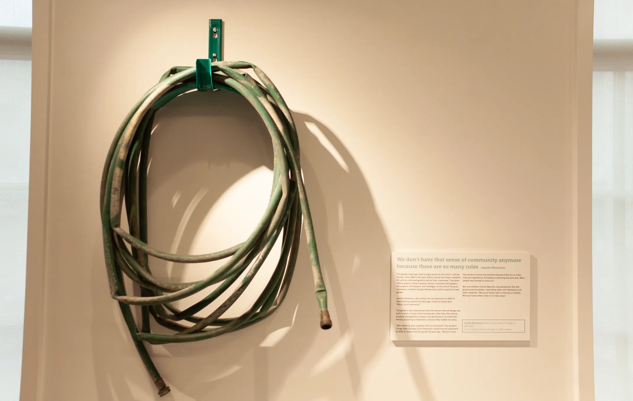 A garden hose coiled on a hook on the wall of the National Public Housing Museum