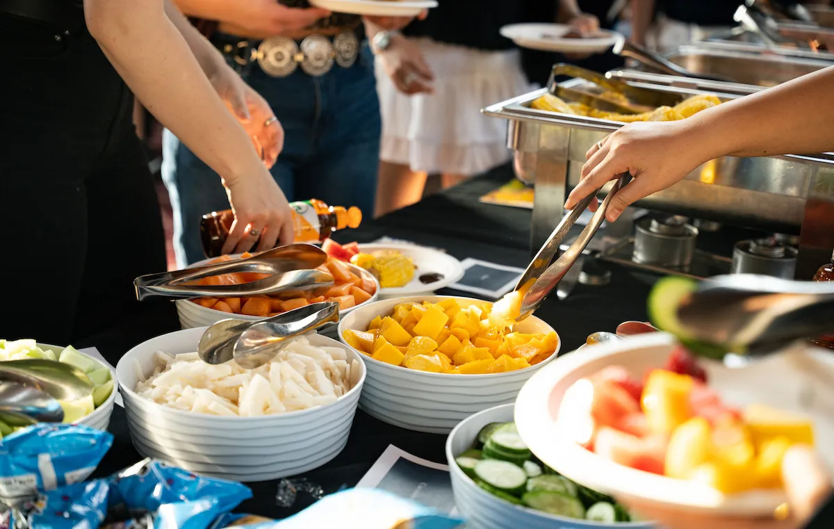 “Students selecting fresh food at the Las Mujeres Culture Show dining event at Bryn Mawr College.