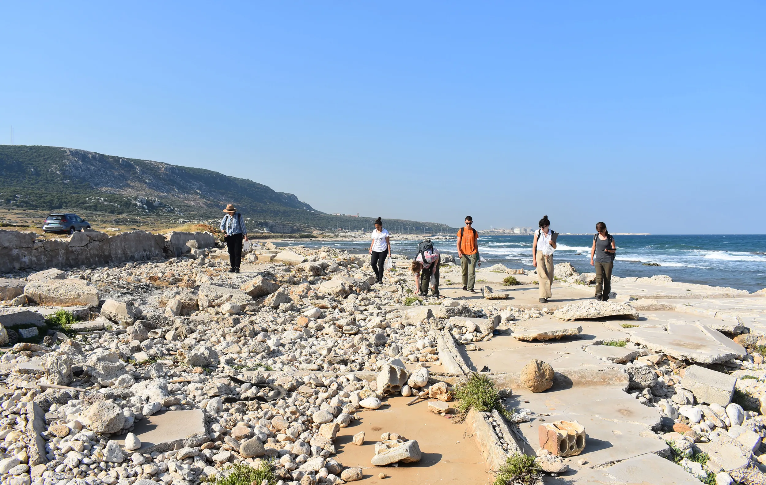 Classical and near eastern Archaeology students walking in sun bleached ruins