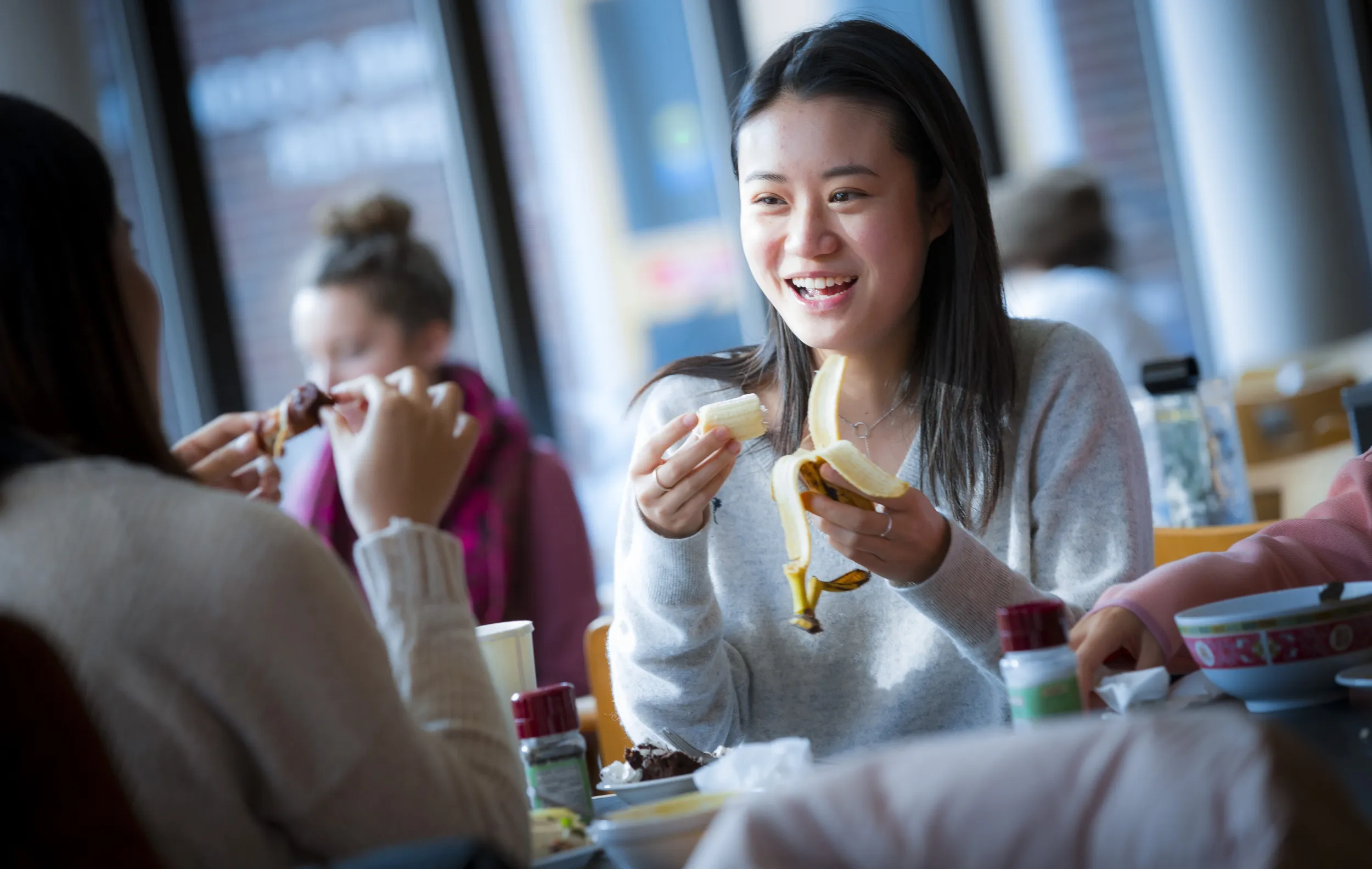 Bryn Mawr College students sharing a meal in a campus dining hall