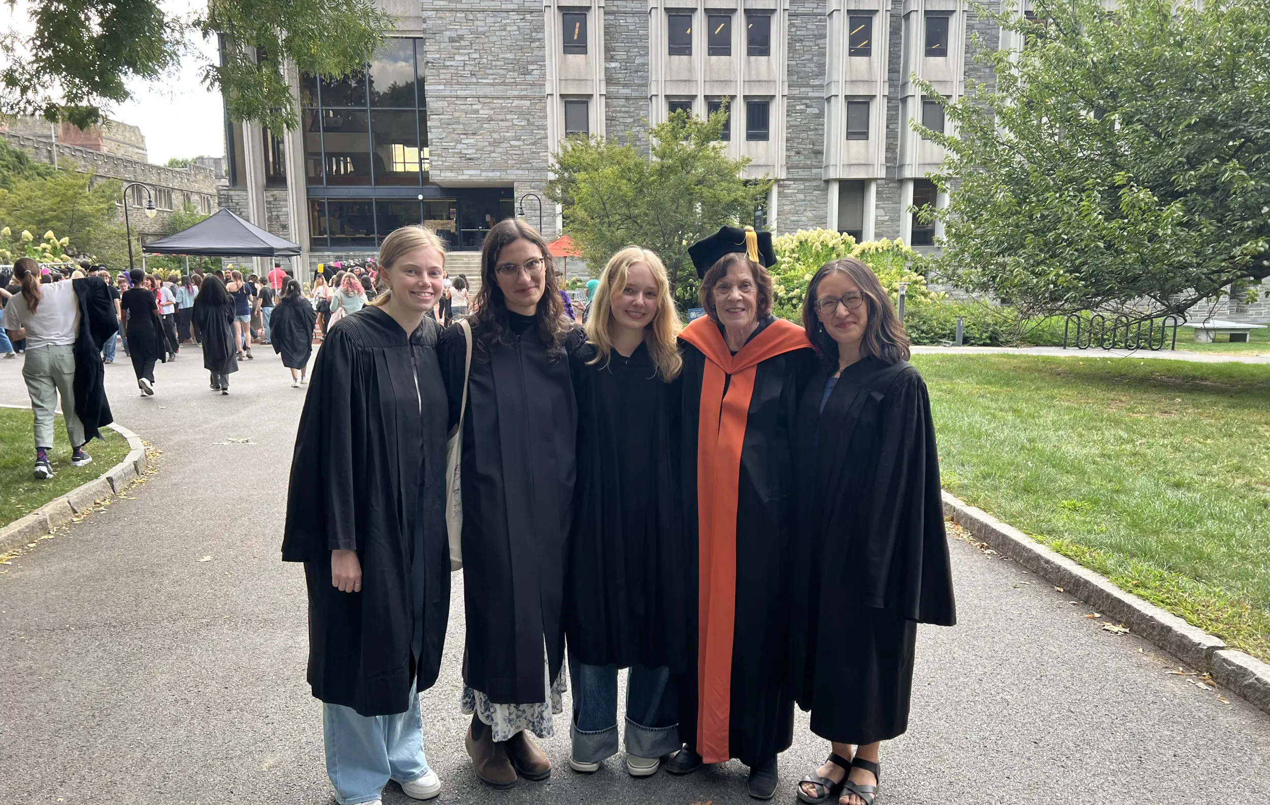Four students and a professor at graduation