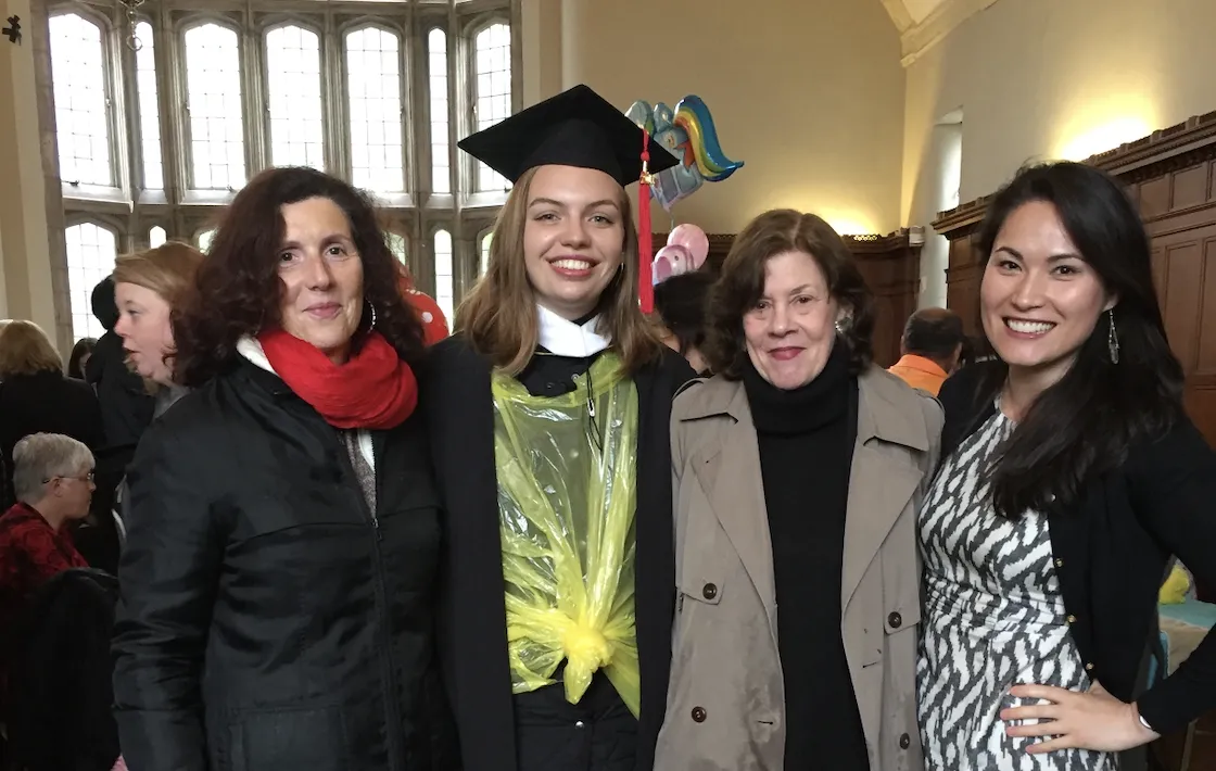 Two students and two professors at graduation