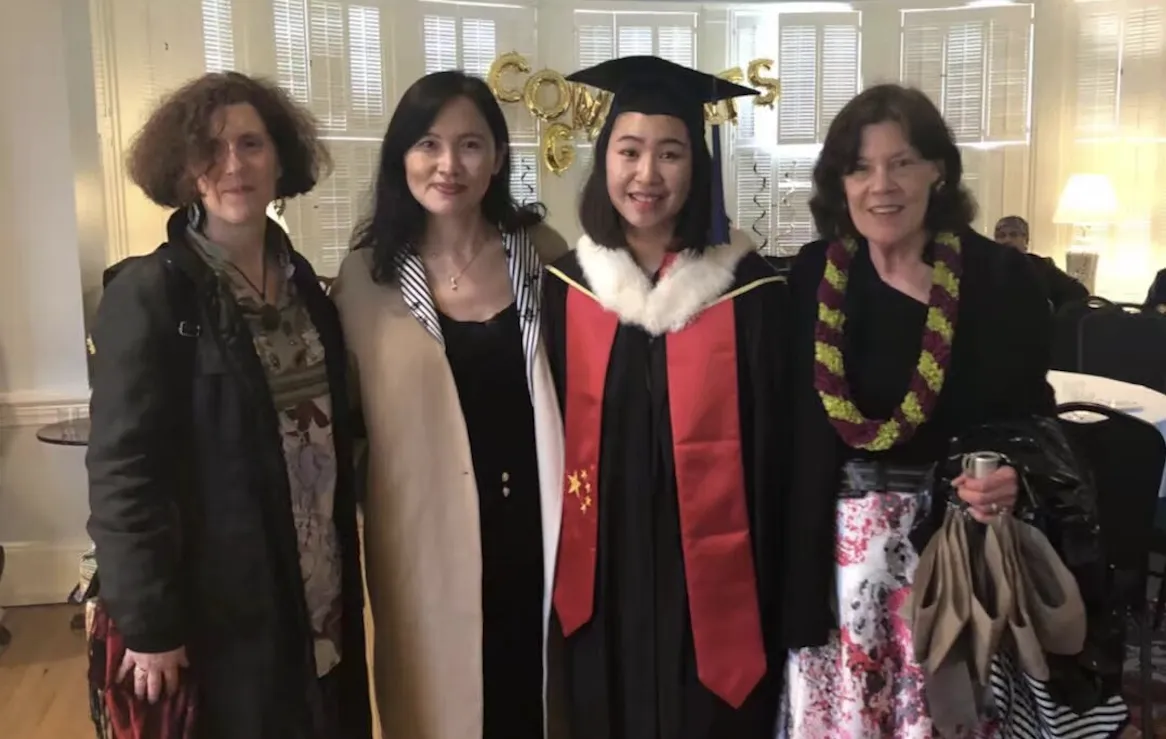 Two professors with a student and her mother at graduation