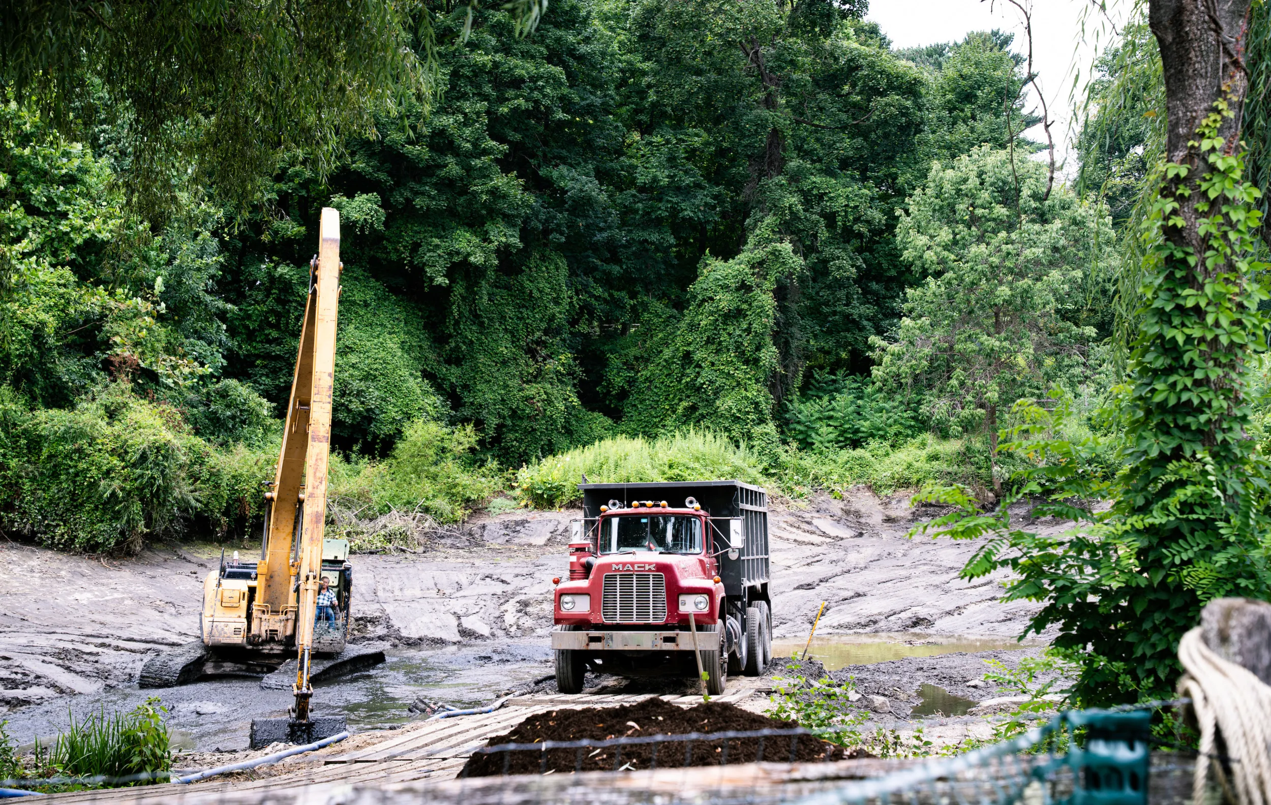 heavy equipment working on dredging the on-campus lake