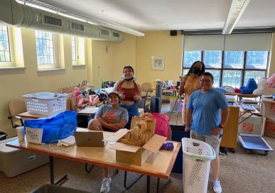 image of Dean Leslie Castrejon with students managing the Dorm Essentials Pick-Up for first-year students