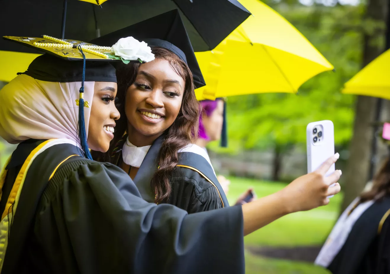 Students taking a selfie at graduation