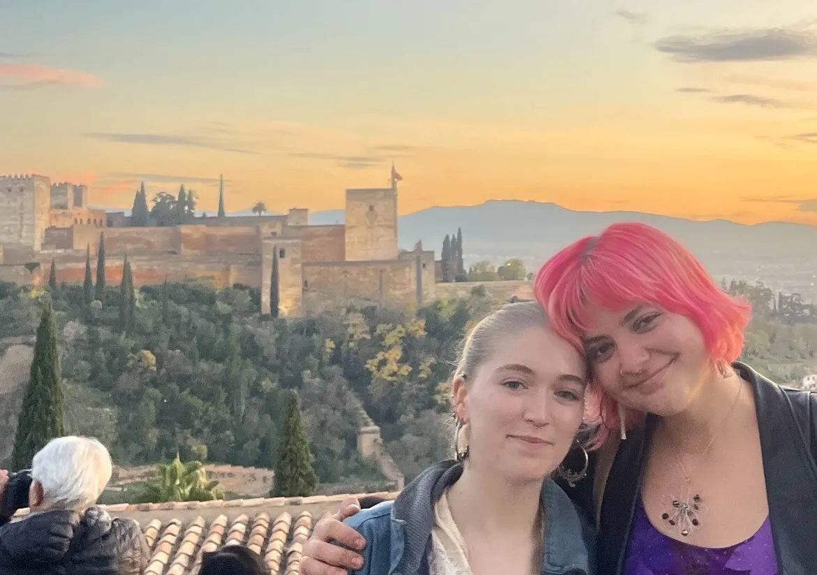 Laurel and friend standing on a hill across from the Alhambra in Granada.
