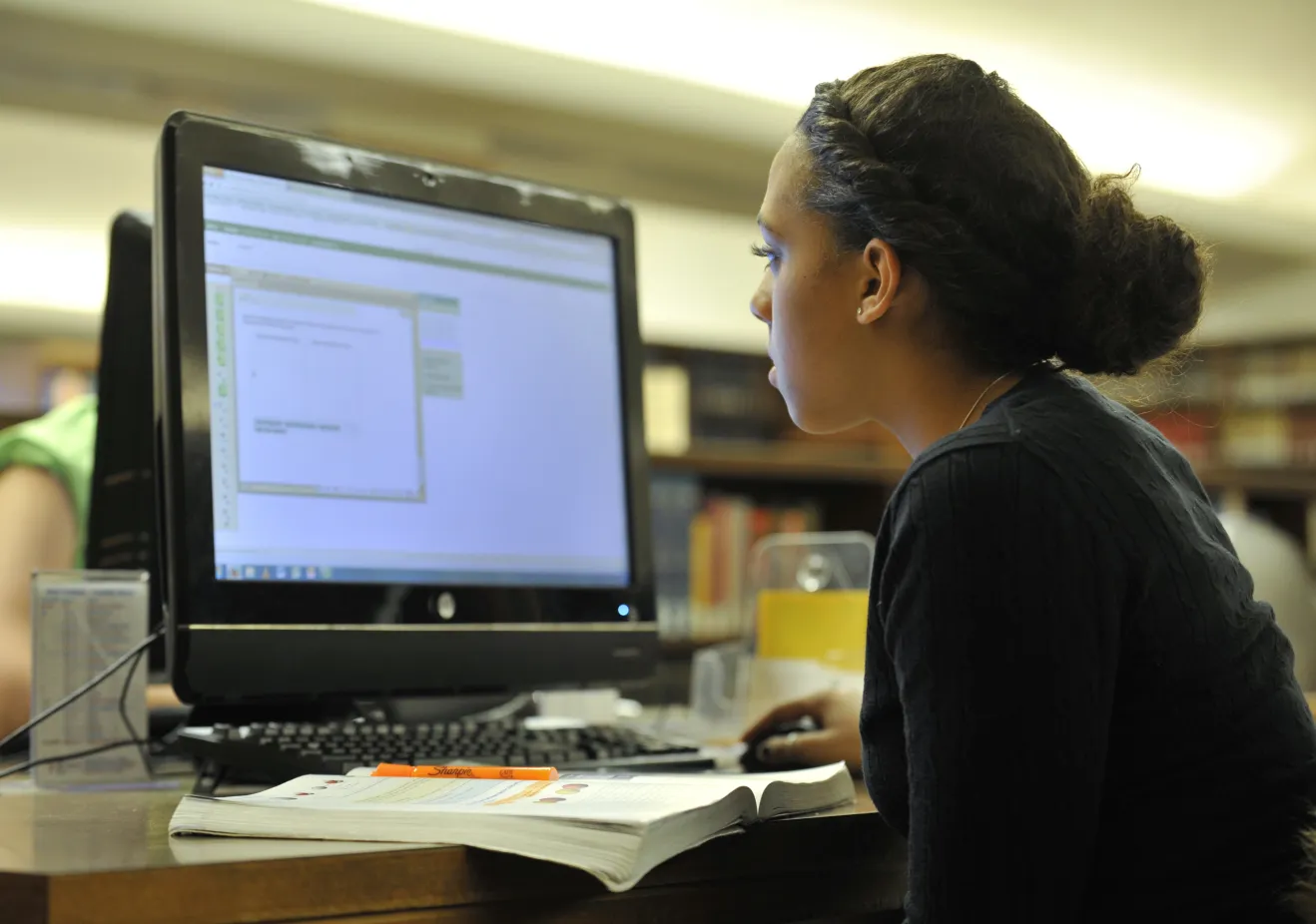 Student sitting doing work at a computer