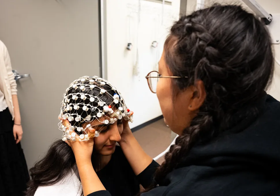 student applying an EEG