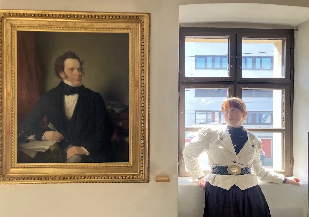 Standing next to a portrait of a musician