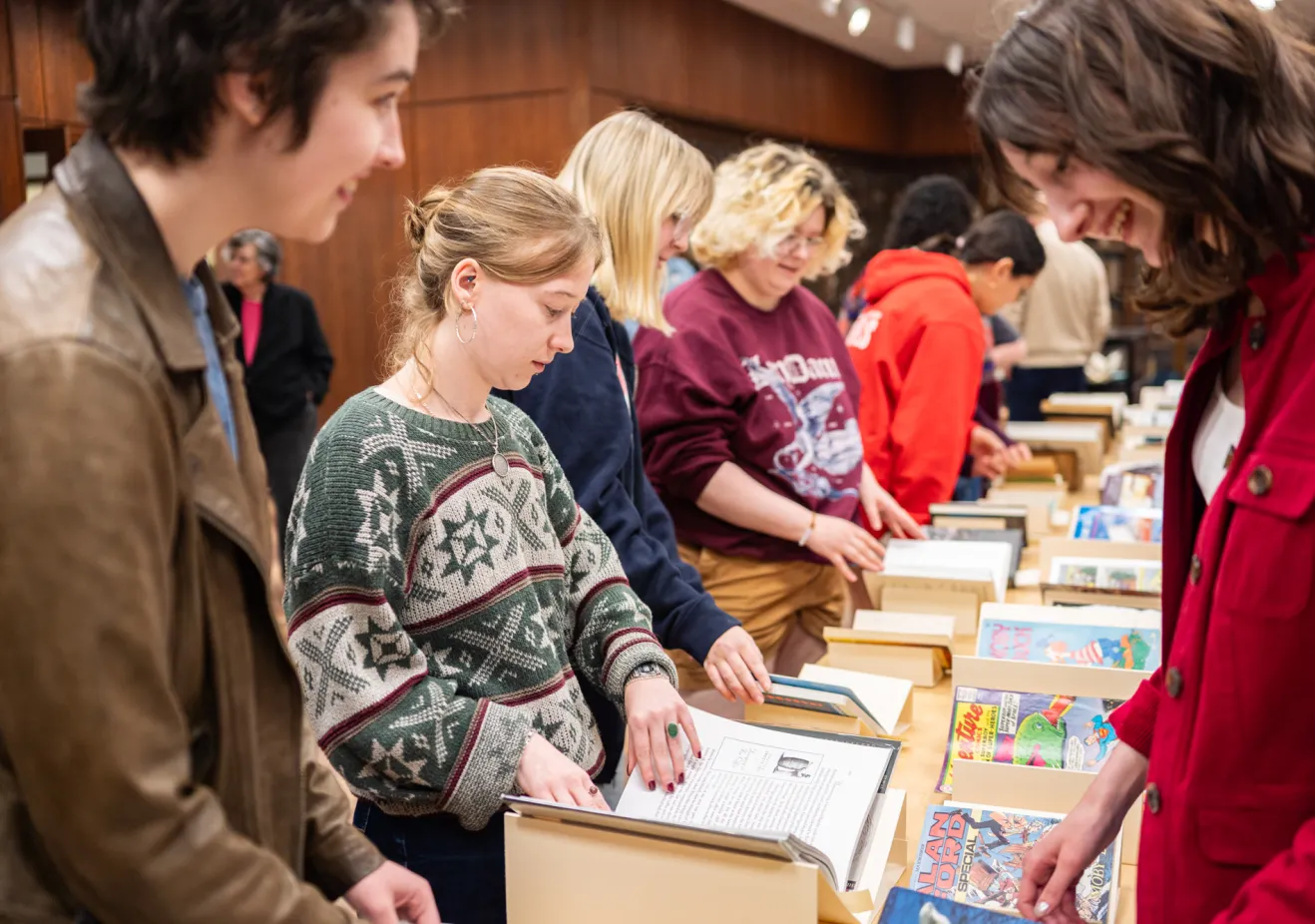Students page through different versions of Moby Dick in Special Collections.