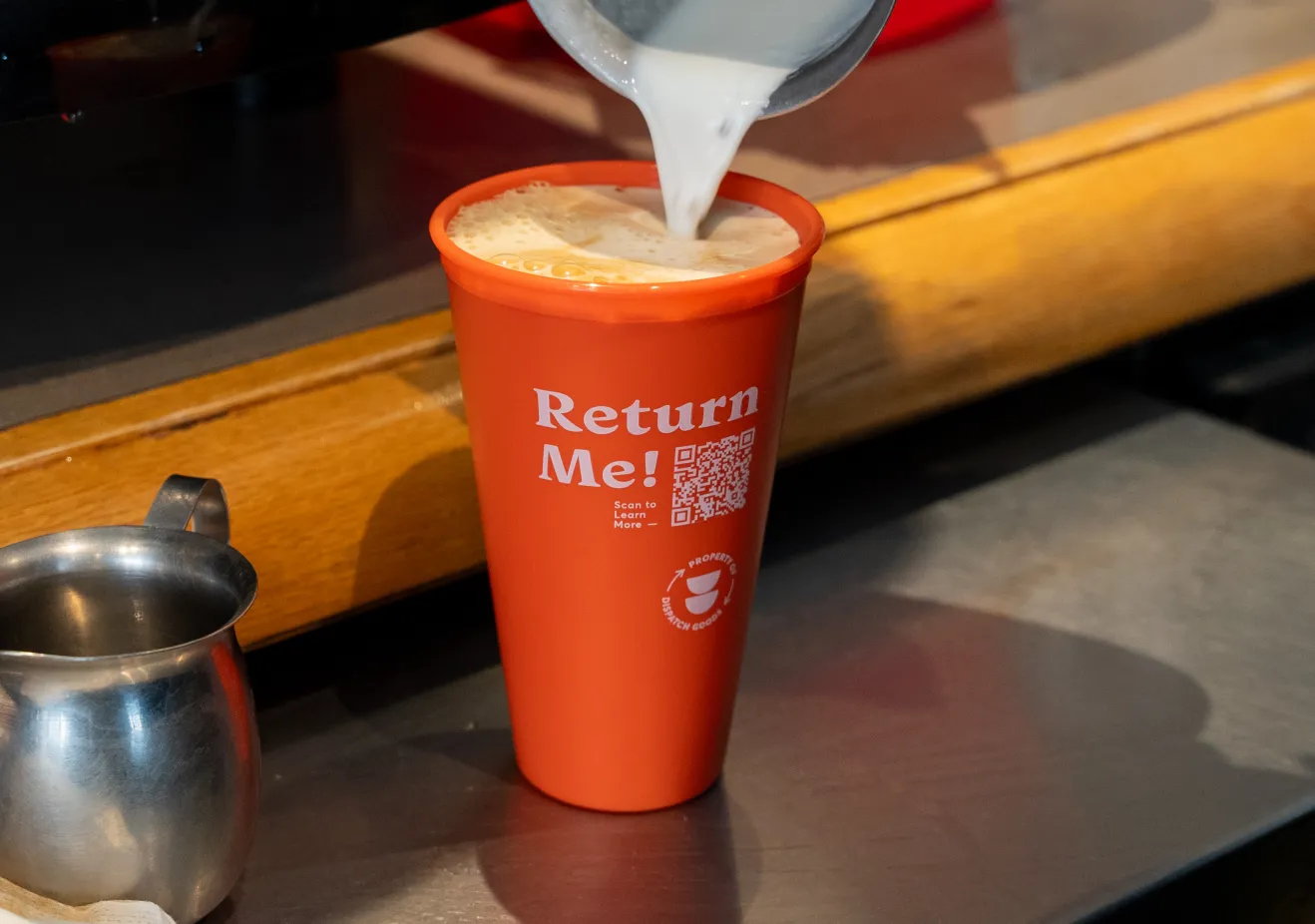 Pouring milk into a reusable cup