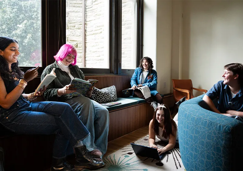 Students laughing in dorm room