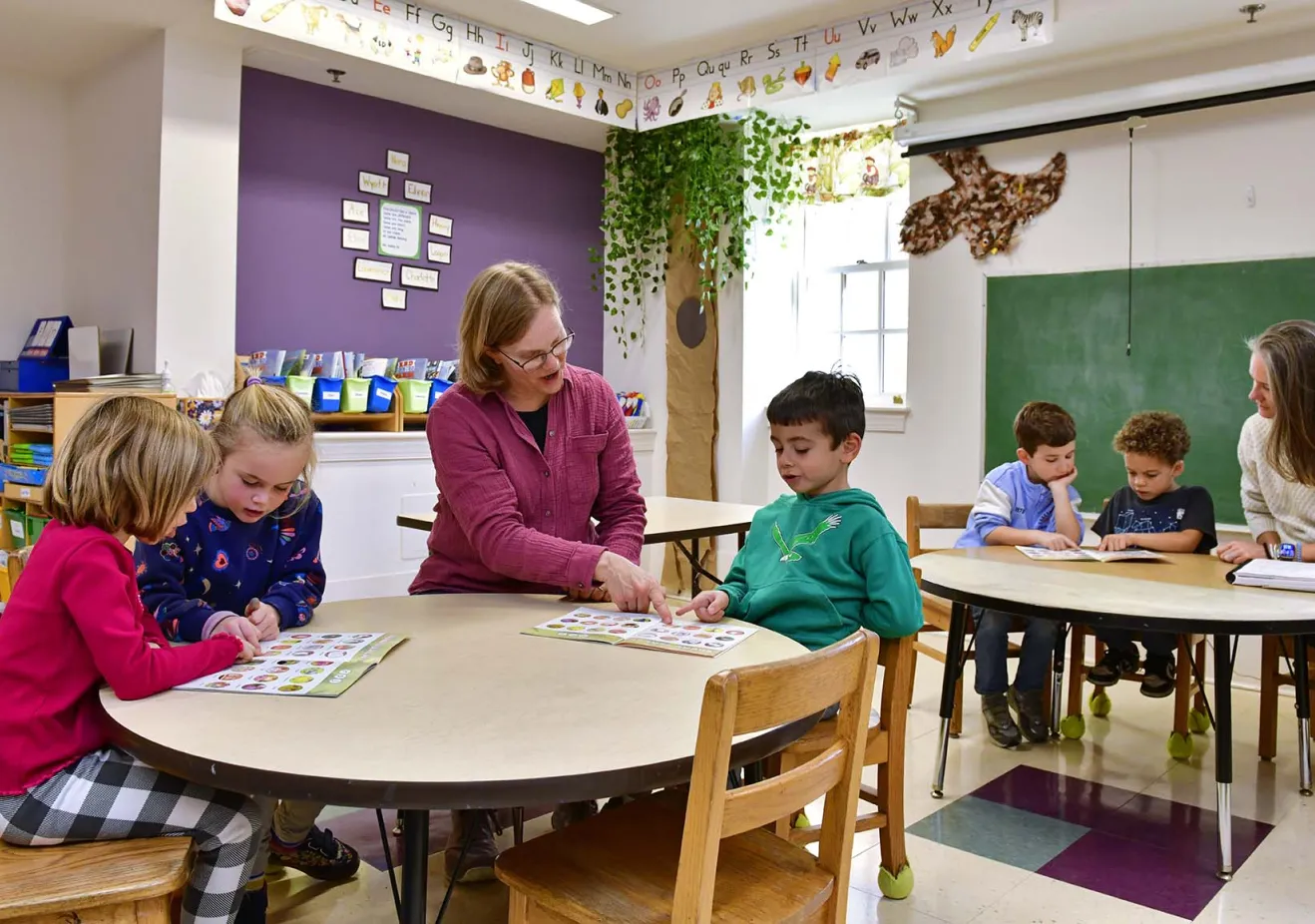 Teachers with small kids at tables