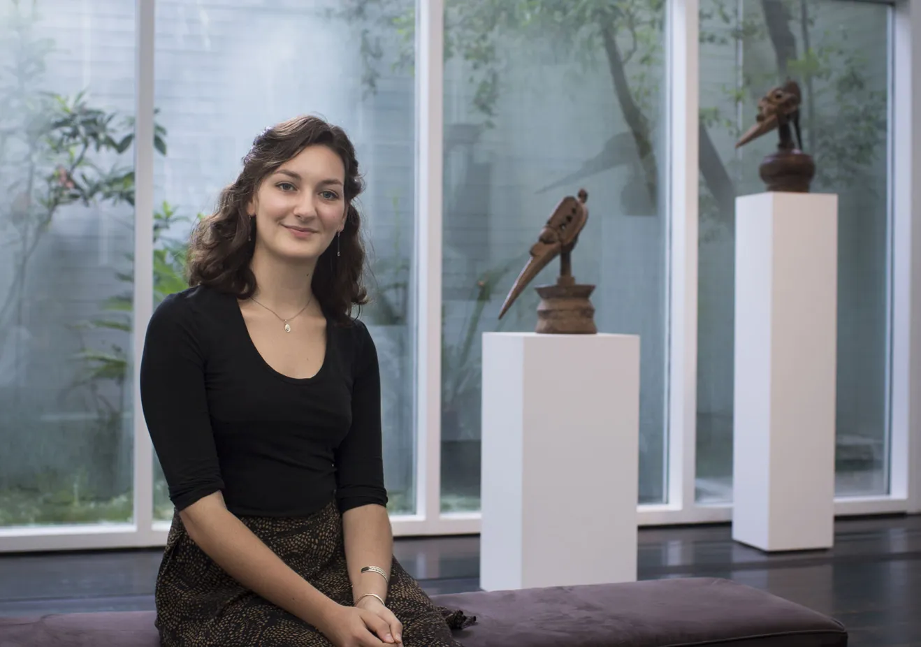 Laura Fields sits in a gallery during her Archaeology Internship
