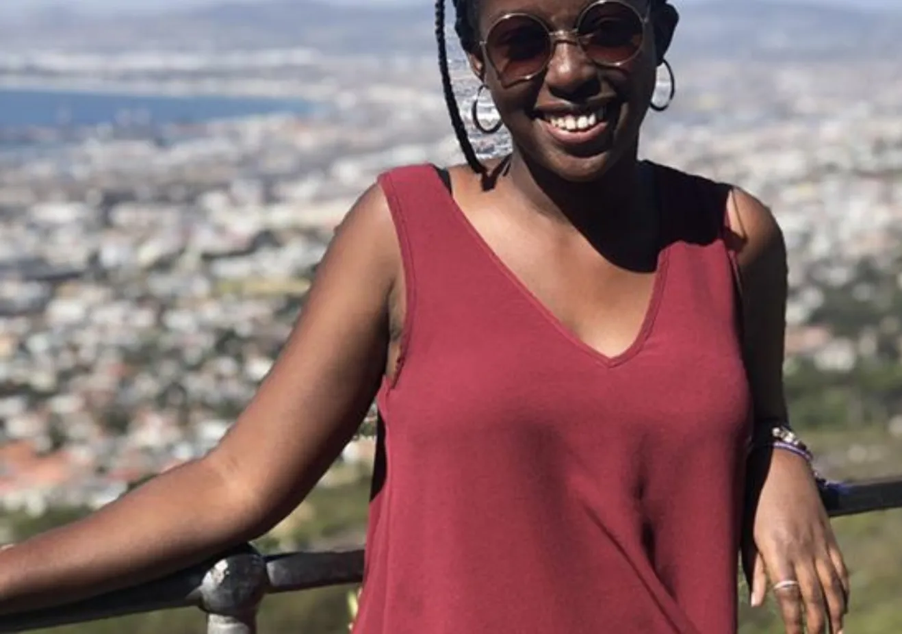A Bryn Mawr College Student studying abroad poses overlooking Cape Town South Africa