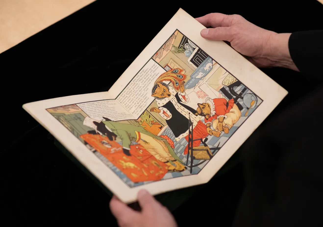 hands opening children's book