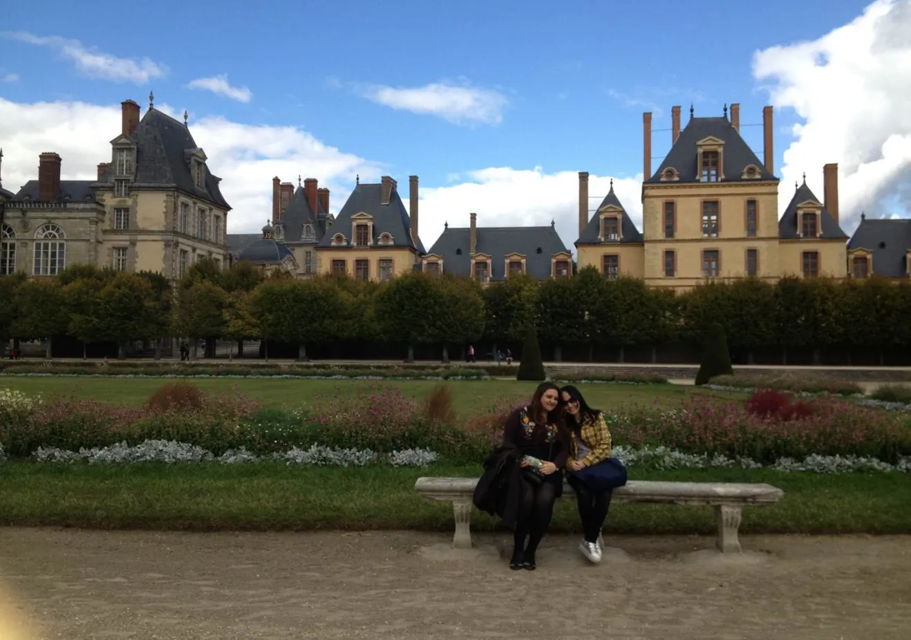 Bryn Mawr students abroad sit in front of a French chateau