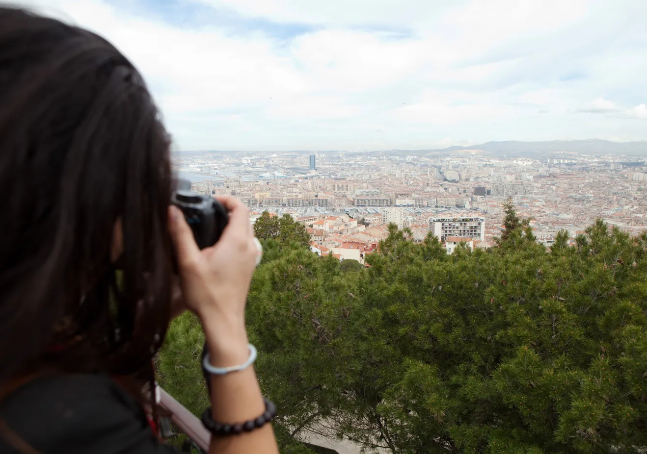 A Bryn Mawr College French Student takes a photograph of the view over Marseille France