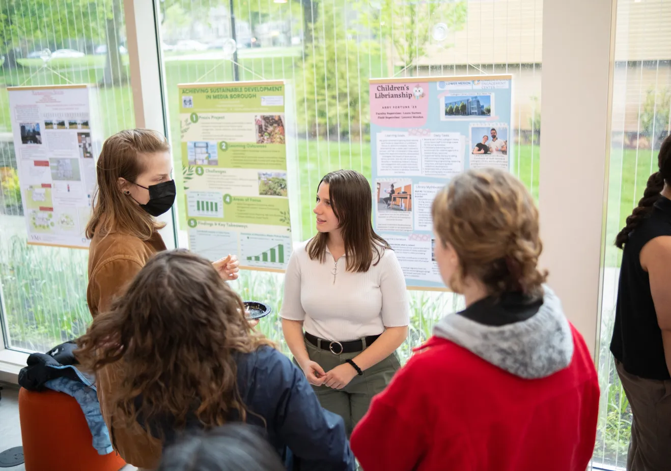 A child and family studies student presents her praxis poster project