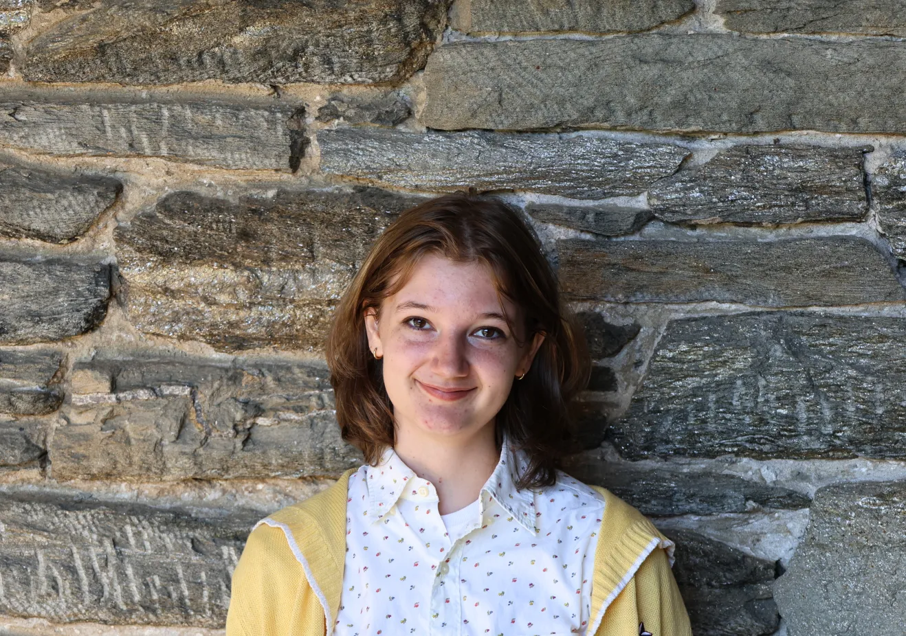 Lucia Iurino poses in front of a stone wall