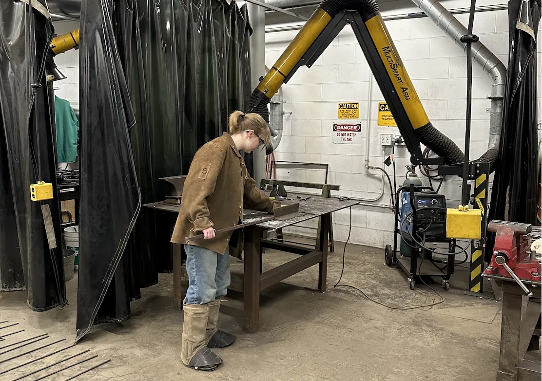 Eleanor welding in a workshop