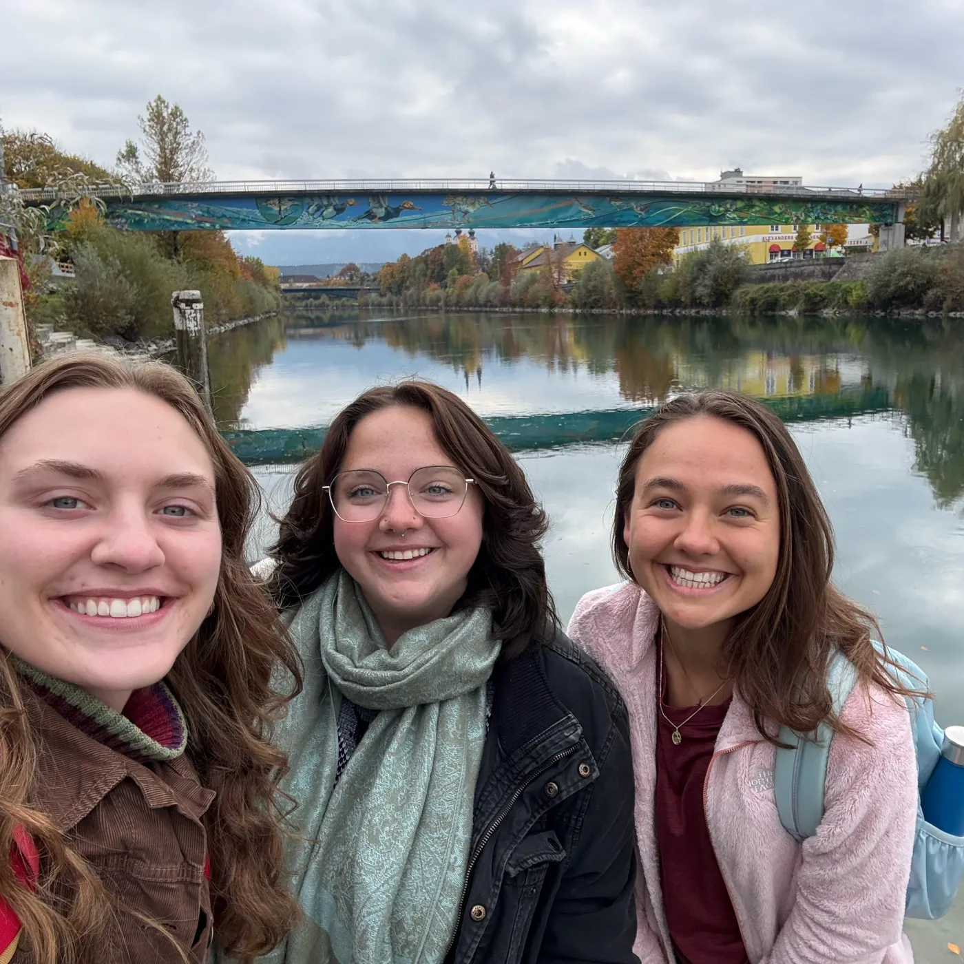 Katie and friends smiling in front of a river