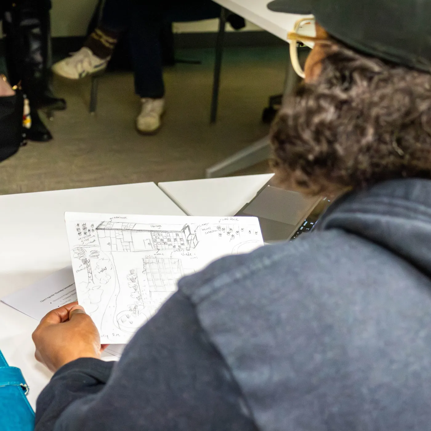 An image of a student looking at a drawing of a potential monument