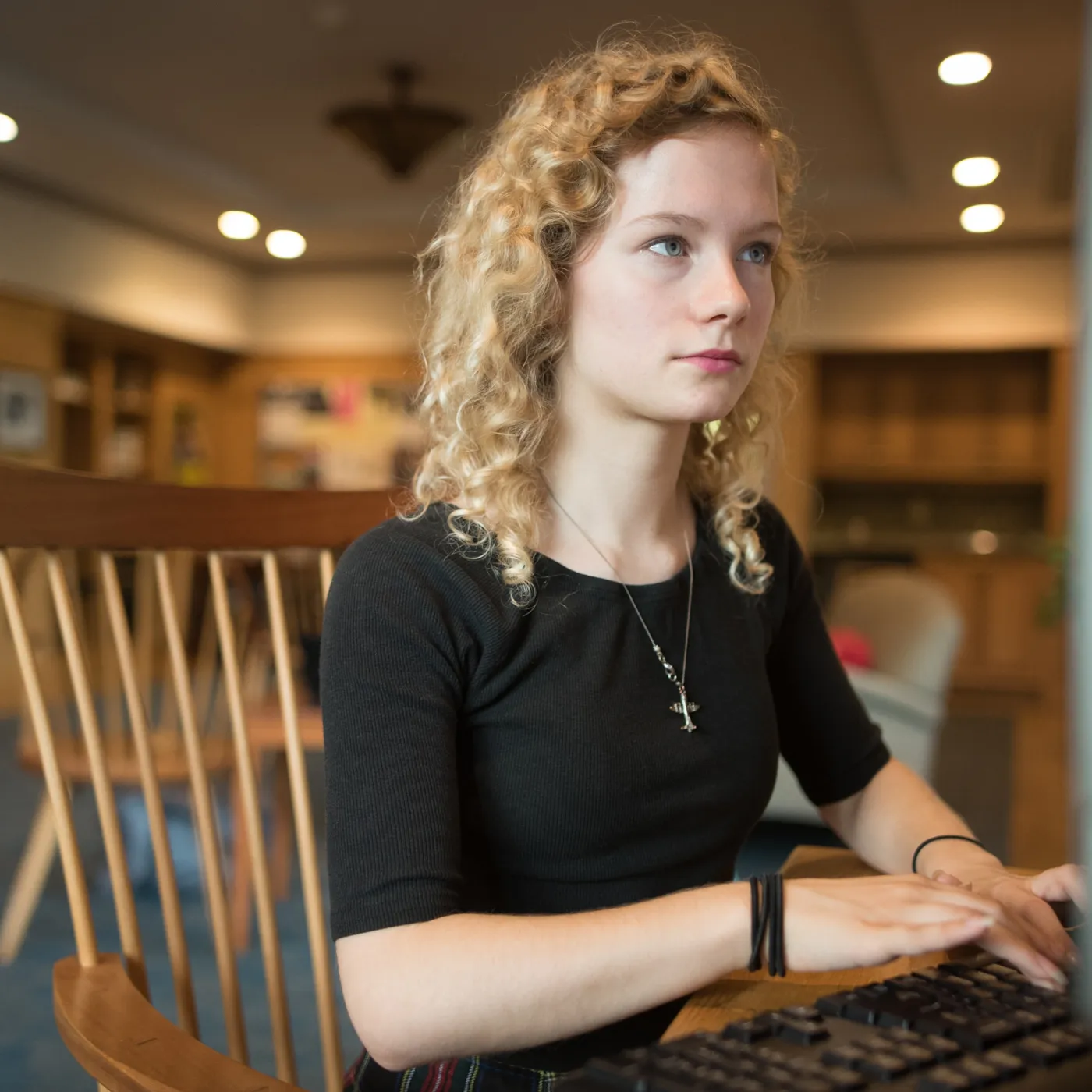 A computer science student sits behind a computer screen