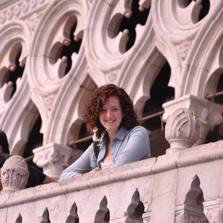 A Transnational Italian Studies student studying abroad in Italy poses in the Doge Palace 