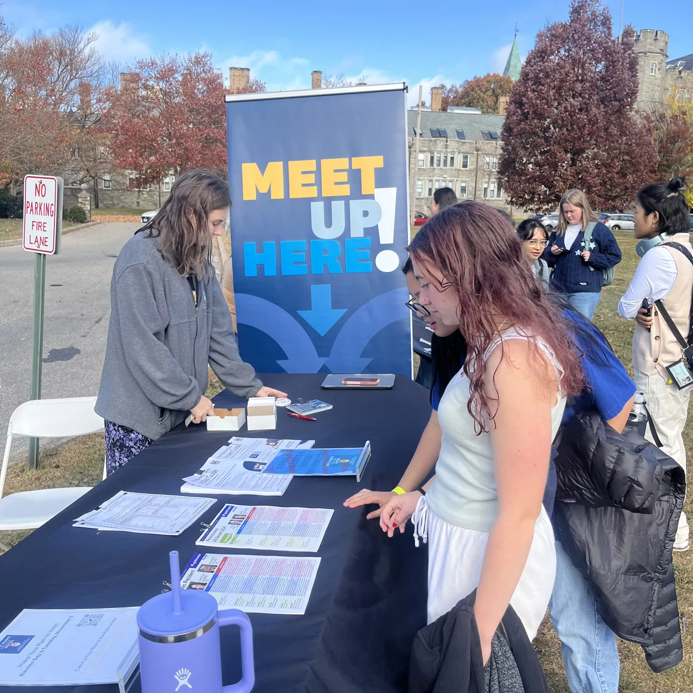 Bryn Mawr College students around a voter registration initiative table
