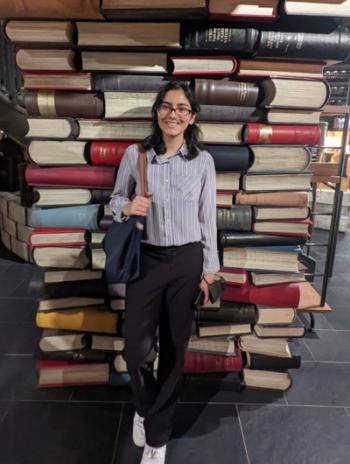 Foqia Sahid standing in front of books