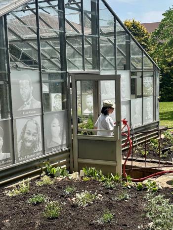 Person walking out of a garden greenhouse